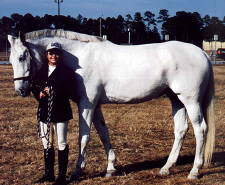 J.R. Khan and me after a Dressage show. He was 18hh (6 feet tall at he withers!)