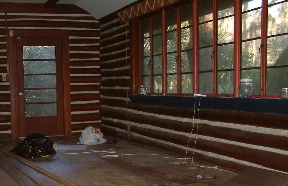Inside of our log cabin, 20x20 living room. Hand-hewn beams. 4 inch wide wooden floors. Wind-out Florida windows.